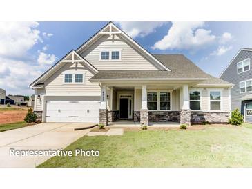 Two-story home with stone accents and a front porch at 4010 Cedar Falls Dr # 23, Waxhaw, NC 28173