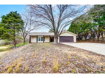 Tan one-story house with brown garage door and covered porch at 11015 Vista Haven Dr, Charlotte, NC 28226