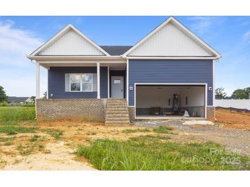 Charming blue home with a bright white trim, front porch, and a two-car garage at 149 Tranquility Ln, Harmony, NC 28634