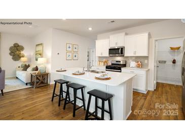 Modern kitchen with island, stainless steel appliances, and white cabinets at 202 Brinkley Dr # 11, Kings Mountain, NC 28086