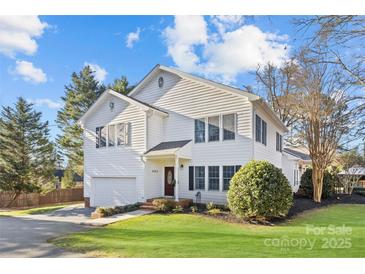 Two-story house with white siding, a large garage, and a well-maintained lawn at 5204 Sardis Rd, Charlotte, NC 28270