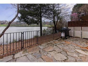 Stone patio with grill, overlooking a lake at 617 Crosswater Ln # B, Fort Mill, SC 29708