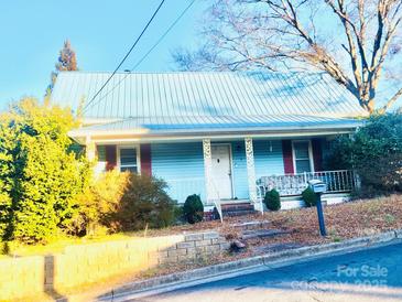 Light blue house with metal roof and mature trees at 510 Austin St, Albemarle, NC 28001