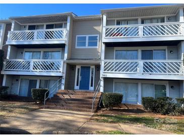 Two-story building exterior with blue door and multiple balconies at 9401 Old Concord Rd # K, Charlotte, NC 28213