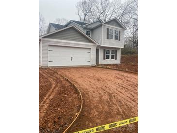 Two-story house with gray siding, attached garage, and a newly landscaped yard at 104 Springdale St, Shelby, NC 28150
