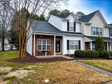 Brick front townhouse with landscaped yard and walkway at 12548 Hennigan Place Ln, Charlotte, NC 28214