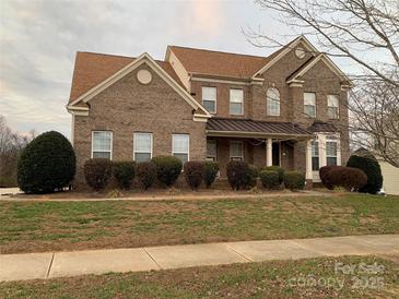 Brick two-story house with a large front yard and landscaping at 1916 Seefin Ct, Indian Trail, NC 28079