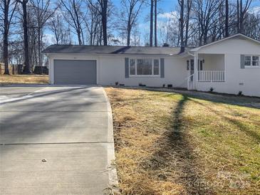 Newly renovated house with a gray garage door and a spacious yard at 801 Crestridge Rd, Statesville, NC 28677