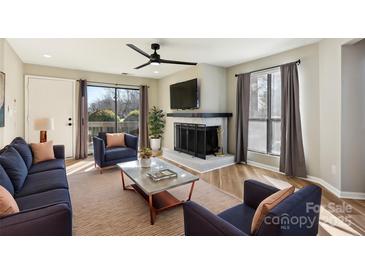 Bright living room features a fireplace, hardwood floors, and ample natural light at 8103 Cedar Glen Dr, Charlotte, NC 28212