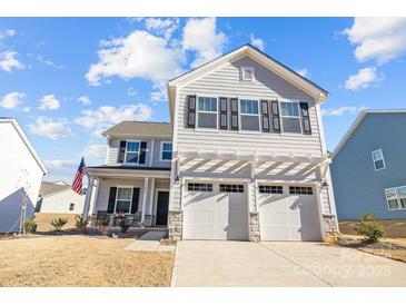 Two-story house with gray siding, two-car garage, and a small front porch at 11058 Argosy Dr, Lancaster, SC 29720