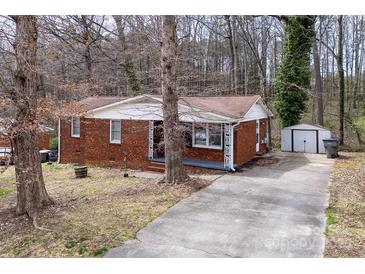 Charming brick home with a covered front porch and ample parking space at 1418 Nottingham Rd, Kannapolis, NC 28081