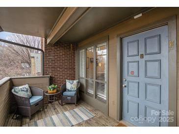 Charming outdoor patio with cushioned seating and a view, perfect for relaxing and unwinding at 421 N Church St # 12F, Charlotte, NC 28202