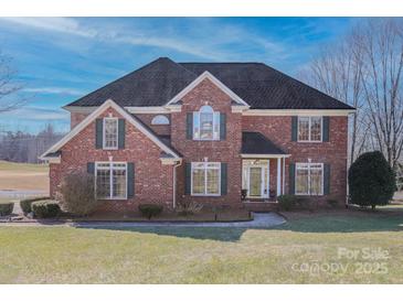 Brick two-story house with a large front yard and dark roof at 104 Fox Den Cir, Statesville, NC 28677