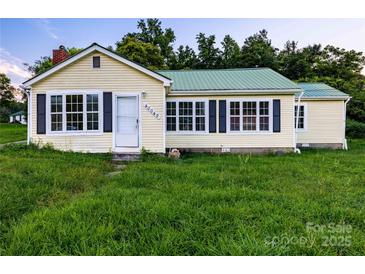 Ranch house with green metal roof, and large yard at 40049 Nc 740 Hwy, New London, NC 28127