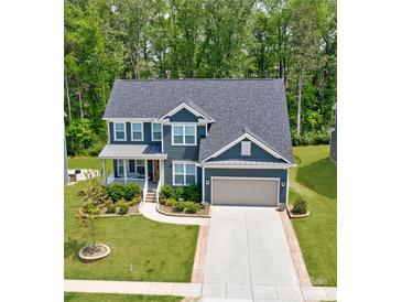 Charming two-story home with a well-maintained lawn and a two-car garage in a desirable neighborhood at 1224 Regions Blvd, Fort Mill, SC 29707