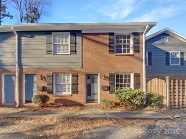 Brick and gray siding townhouse exterior with landscaping at 638 Chipley Ave # 6, Charlotte, NC 28205