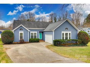 Ranch style home with gray siding, attached garage, and landscaped yard at 814 Water Wheel Ct, Charlotte, NC 28209