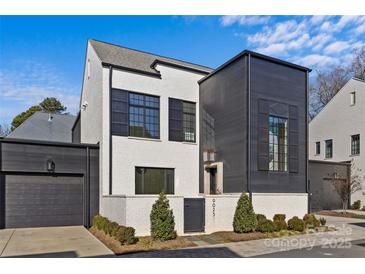 Stylish two-story home with black and white exterior and landscaping at 9025 Tynecastle Commons Ct # 2, Charlotte, NC 28226