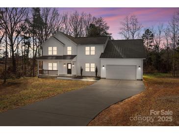 Two-story white house with gray roof, attached garage, and a long driveway at 116 Desert Sky Ct, Statesville, NC 28625