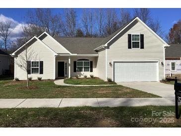 Newly constructed craftsman style home with attached garage and manicured lawn at 5126 Rocky River Crossing Rd, Harrisburg, NC 28075