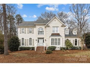 Two-story brick home with gray shutters and a landscaped yard at 6604 Morrowick Circle Dr, Charlotte, NC 28226