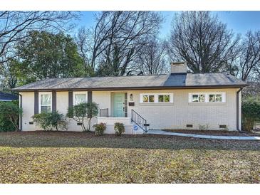 Charming single-story painted brick home with a light teal front door and mature landscaping at 738 Brockbank Rd, Charlotte, NC 28209