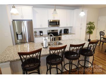 Modern kitchen with stainless steel appliances and granite countertops at 1028 Sharon Towns Dr, Charlotte, NC 28210