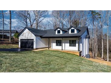 Two-story house with a white exterior, black roof, and attached garage at 115 Brentwood Dr, Maiden, NC 28650