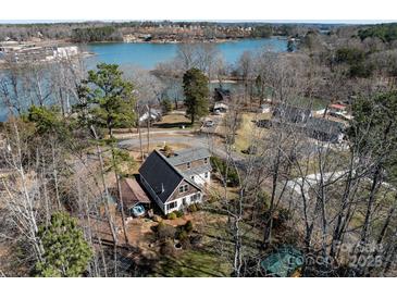 Stunning aerial view of lakefront home with mature trees and private access to the water at 4465 Red Hill Cir, Denver, NC 28037