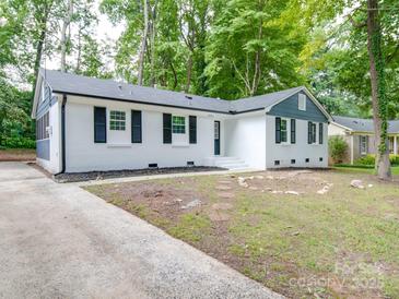 Charming white house with blue accents and a spacious front yard at 5224 Kildare Dr, Charlotte, NC 28215