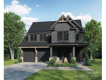 Two-story modern farmhouse with gray siding, attached garage, and landscaping at 2633 Ritz Ln, Matthews, NC 28105