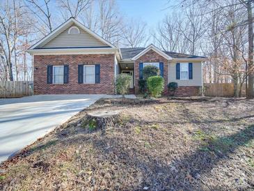 Brick ranch home with attached garage and landscaped yard at 3607 Truxton Ct, Waxhaw, NC 28173