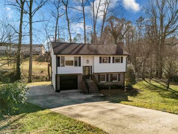 Charming ranch home with a spacious driveway and mature trees at 6440 Kathyrn Ct, Belmont, NC 28012