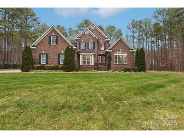 Brick two-story house with a lush green lawn at 7282 James Ct, Denver, NC 28037