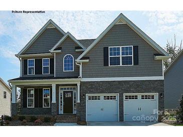 Two-story house with gray siding, stone accents, and a two-car garage at 8016 Plymouth Dr, Sherrills Ford, NC 28673