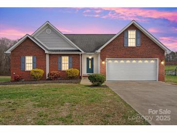 Brick ranch house with attached garage and landscaped lawn at 104 Brookview Dr, Shelby, NC 28152