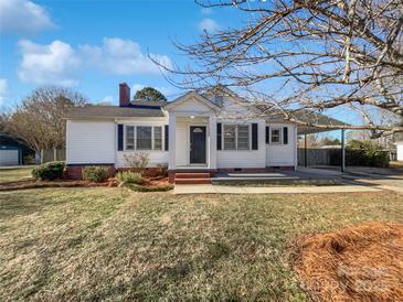 Charming white house with a spacious lawn and mature trees at 1215 Neal Hawkins Rd, Gastonia, NC 28056