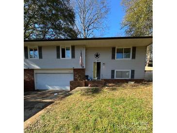 Ranch style home with attached garage and landscaped yard at 1309 Poplar Cir, Newton, NC 28658