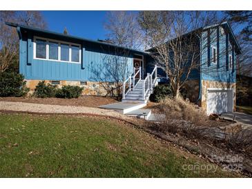 Ranch style home with blue siding, stone accents, and a white staircase at 1432 Jules Ct, Charlotte, NC 28226