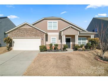 Two-story house with stone accents and a landscaped yard at 1527 Sunflower Field Pl, Matthews, NC 28104