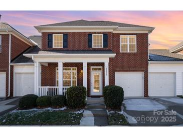 Brick front exterior of charming townhome with front porch and landscaping at 20215 Middletown Rd, Cornelius, NC 28031