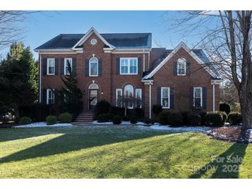 Brick two-story house with a large front yard and mature trees at 21711 Shoveller Ct, Cornelius, NC 28031