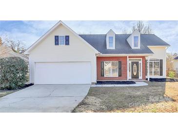 Charming home featuring brick and siding, two-car garage and well maintained lawn at 2820 Rosemeade Dr, Monroe, NC 28110