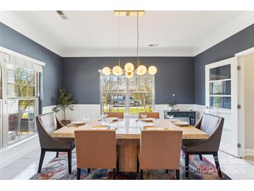 Bright dining room with a large table and modern chandelier at 2943 Tallgrass Blf, Rock Hill, SC 29732