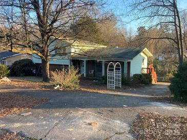 Ranch home with covered porch and mature trees at 3326 Winterfield Pl, Charlotte, NC 28205