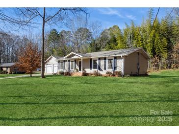 Ranch home with attached garage and spacious lawn at 3705 Pinecrest Dr, Gastonia, NC 28056