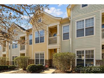 Inviting townhome exterior boasts charming architectural details and landscaping at 4126 Walker Rd, Charlotte, NC 28211