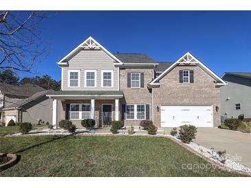 Two-story brick home with a large front yard and landscaping at 5030 Monacan Way, Indian Land, SC 29707