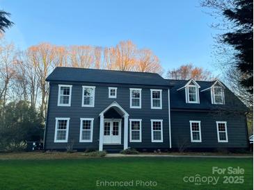 Charming two-story home boasts a classic design with white-trimmed windows and a well-manicured lawn at 5229 Mt Holly Huntersville Rd, Charlotte, NC 28216