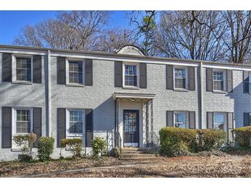 Brick building with gray shutters, a black door, and well-manicured hedges at 533 Wakefield Dr # B, Charlotte, NC 28209